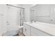 Well-lit bathroom featuring a shower-tub combo and a sleek, white vanity at 126 S Vandriver Way, Aurora, CO 80018