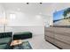 Well-lit bonus room with a large television, modern furniture, and neutral carpeting at 126 S Vandriver Way, Aurora, CO 80018