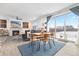 Charming dining area open to the living room, featuring a modern fireplace and sliding glass doors at 126 S Vandriver Way, Aurora, CO 80018