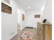 Inviting hallway with a decorative rug, and a view of the front door at 126 S Vandriver Way, Aurora, CO 80018