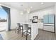 Well-lit kitchen with an island, white cabinets, stainless steel appliances, and stylish pendant lighting at 126 S Vandriver Way, Aurora, CO 80018