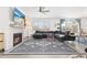 Comfortable living room featuring a modern fireplace, stylish decor, and sliding glass doors to the backyard at 126 S Vandriver Way, Aurora, CO 80018