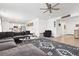 Spacious open-concept living room showcasing a large sectional sofa, modern decor, and seamless kitchen access at 126 S Vandriver Way, Aurora, CO 80018