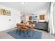 Open concept living room and dining area with modern decor and plenty of natural light at 126 S Vandriver Way, Aurora, CO 80018