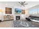 Bright living room features a fireplace, modern ceiling fan, and comfortable gray sectional sofa at 126 S Vandriver Way, Aurora, CO 80018