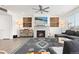 Inviting living room featuring a cozy fireplace, modern ceiling fan, and comfortable sectional sofa at 126 S Vandriver Way, Aurora, CO 80018