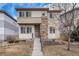 Charming two-story home features a stone facade, well-maintained lawn, and welcoming entrance at 3389 Cranston Cir, Highlands Ranch, CO 80126