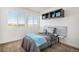 Bright bedroom with scenic views, and a bed with a blue blanket at 3389 Cranston Cir, Highlands Ranch, CO 80126