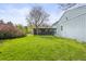 Expansive green backyard featuring a black brick exterior, blue siding and mature trees at 3995 Easley Rd, Golden, CO 80403