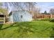 Exterior side yard featuring green lawn, a blue shed and a wooden fence at 3995 Easley Rd, Golden, CO 80403