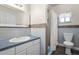Bathroom featuring a sink, mirror, tiling detail, and a shower-tub combination at 3995 Easley Rd, Golden, CO 80403