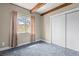Cozy carpeted bedroom featuring a window and a closet with sliding doors at 3995 Easley Rd, Golden, CO 80403