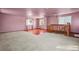 Large bonus room featuring carpet, wood staircase, ceiling fan, and natural light from two windows at 3995 Easley Rd, Golden, CO 80403