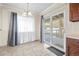 Bright dining area featuring neutral tones, tile flooring, and sliding glass doors to let in natural light at 3995 Easley Rd, Golden, CO 80403