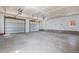 Spacious two car garage featuring white walls, concrete floors and two paneled garage doors at 3995 Easley Rd, Golden, CO 80403