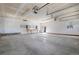 View of the spacious garage featuring a work bench and access to the exterior through a white door at 3995 Easley Rd, Golden, CO 80403