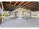 Large covered outdoor space featuring brick exterior and a picnic table at 3995 Easley Rd, Golden, CO 80403