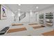 Spacious basement area for activities with yoga mats and shelves for storage in a bright and well-lit room at 6716 W Rowland Ave, Littleton, CO 80128