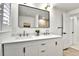 Bright bathroom with double sink vanity, bright lighting, and quartz countertops at 6716 W Rowland Ave, Littleton, CO 80128