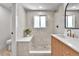 Bright bathroom with tiled walk-in shower, tiled bench and vanity sink at 6716 W Rowland Ave, Littleton, CO 80128