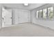Bright bedroom with a neutral color palette, carpet flooring, and shuttered window at 6716 W Rowland Ave, Littleton, CO 80128