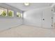 Bright bedroom with neutral carpet, shuttered window, and bright white walls at 6716 W Rowland Ave, Littleton, CO 80128