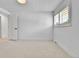 Bright bedroom with neutral carpet, shuttered window, and bright white walls at 6716 W Rowland Ave, Littleton, CO 80128