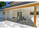 Cozy covered patio with stone flooring, ceiling fan, and stylish outdoor seating for relaxing or entertaining at 6716 W Rowland Ave, Littleton, CO 80128
