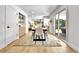 Dining room with a large table and seating, open to kitchen and featuring hardwood flooring at 6716 W Rowland Ave, Littleton, CO 80128
