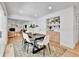 Dining room features a large wooden table, bright white walls, and hardwood flooring at 6716 W Rowland Ave, Littleton, CO 80128