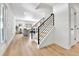 Bright foyer with modern staircase and wood flooring, leading to the living area at 6716 W Rowland Ave, Littleton, CO 80128