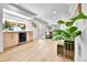 Open-concept kitchen with bright white walls and ceiling, a wine refrigerator, and a large window at 6716 W Rowland Ave, Littleton, CO 80128