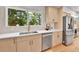 Bright kitchen with stainless steel appliances, white countertops, and a large window with a view at 6716 W Rowland Ave, Littleton, CO 80128