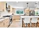 Bright kitchen with an island and breakfast bar, sleek appliances, and plenty of storage at 6716 W Rowland Ave, Littleton, CO 80128