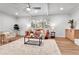 Cozy living room with a fireplace, hardwood floors, and neutral decor at 6716 W Rowland Ave, Littleton, CO 80128
