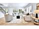Bright and airy living room with white walls, wood floors, shutters, and modern decor at 6716 W Rowland Ave, Littleton, CO 80128