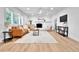 Bright living room with a fireplace, hardwood flooring, and plantation shutters at 6716 W Rowland Ave, Littleton, CO 80128