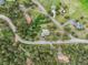 Aerial view shows house nestled in mature trees in wooded neighborhood with surrounding houses at 28465 Cragmont Dr, Evergreen, CO 80439