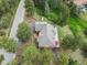 Overhead aerial view of the house, its roof, and large deck surrounded by mature trees at 28465 Cragmont Dr, Evergreen, CO 80439