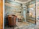 Elegant bathroom with a copper soaking tub and a glass-enclosed shower with wood look tile at 28465 Cragmont Dr, Evergreen, CO 80439