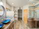 Luxurious bathroom featuring a modern vanity with double sinks, a soaking tub, and a walk-in closet at 28465 Cragmont Dr, Evergreen, CO 80439