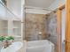 Bathroom featuring a tiled shower and tub combo, tile accents, and white vanity at 28465 Cragmont Dr, Evergreen, CO 80439