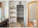 Spacious bathroom hallway featuring an adjacent walk-in closet and a half bath at 28465 Cragmont Dr, Evergreen, CO 80439