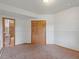 Bedroom featuring closet, attached bathroom, neutral walls and carpet at 28465 Cragmont Dr, Evergreen, CO 80439