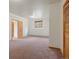 The bedroom features multiple doors, a window, and neutral carpet and walls at 28465 Cragmont Dr, Evergreen, CO 80439