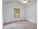 Neutral bedroom featuring a ceiling fan and a window offering natural light at 28465 Cragmont Dr, Evergreen, CO 80439