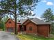 Inviting exterior view of the home featuring a beautiful yard and wood siding at 28465 Cragmont Dr, Evergreen, CO 80439