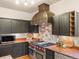 Well-appointed kitchen features stainless steel range, custom hood, and modern appliances at 28465 Cragmont Dr, Evergreen, CO 80439
