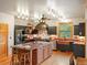 Spacious kitchen with large island, custom range hood, and stainless steel appliances at 28465 Cragmont Dr, Evergreen, CO 80439