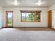 The living room boasts a wooden back door and large windows showcasing the lush landscape at 28465 Cragmont Dr, Evergreen, CO 80439